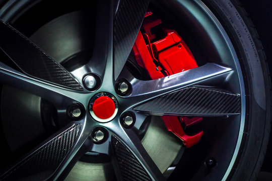 Closeup of an beautiful large Alloy wheel of luxury car with painted brake callipers