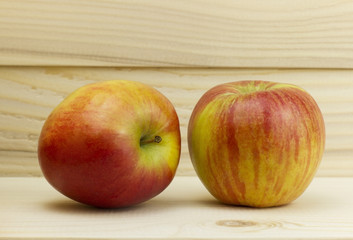 two fresh juicy natural Apple on wooden background