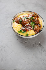 Homemade meatballs in tomato sauce with polenta