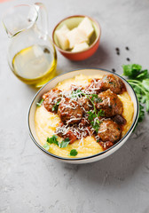 Homemade meatballs in tomato sauce with polenta