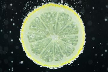 Lemon slice diving into water