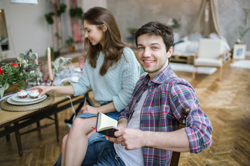 Young happy hipster couple enjoying meal in rustic old loft