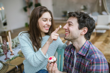 Young happy hipster couple enjoying meal in rustic old loft