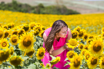 Naklejka na ściany i meble Girl standing in the Tuscan fields in summer
