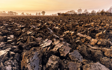 plowed soil. spring field. sunset over ploughed field. Countrysi