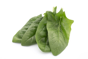 Fresh leaves of spinach on the white background.