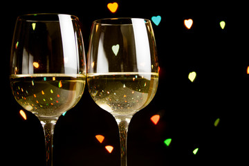 wine glass on hearts bokeh background, concept of valentine's day