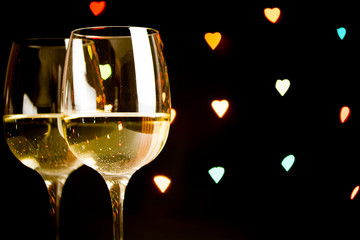 wine glass on hearts bokeh background, concept of valentine's day