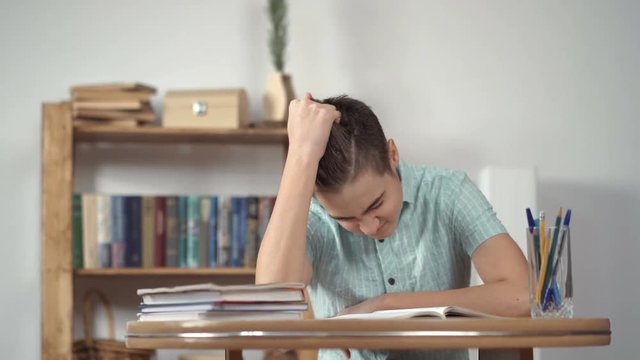 Upset schoolboy doing homework