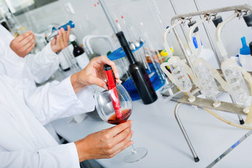 Hands working in chemical laboratory checking wine qualities