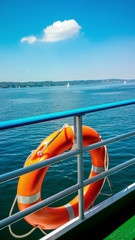 Fototapeta premium Lifebuoy on board ship at blue sky