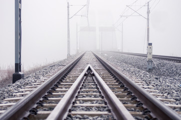 Railroad tracks, foggy winter morning.