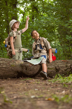 boys on camping trip in the forest exploring