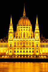 Fototapeta premium Central part of illuminated historical building of Hungarian Parliament on Danube River Embankment in Budapest by night, Hungary, Europe.