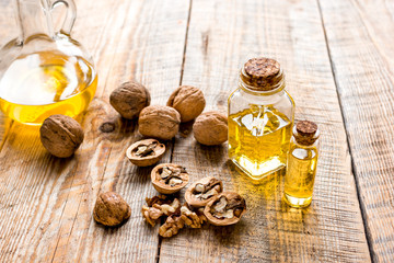 cosmetic and therapeutic walnut oil on wooden background