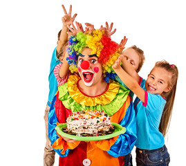 Birthday child clown playing with children. Kid cakes celebratory in hands of events organizer man. Fooling of group people celebrate party on white background. Children pulling bunny fingers prank on