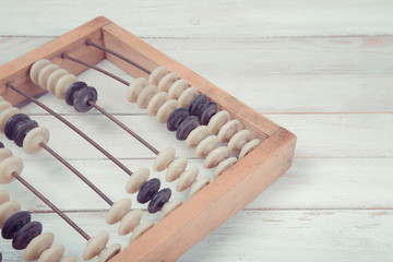 Old vintage abacus on wooden background