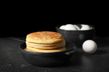Stack of fresh pancakes in pan on table