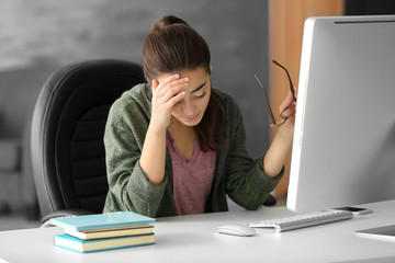 Tired young woman working in office