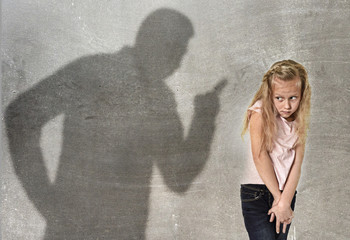 father or teacher shadow screaming angry reproving young sweet little schoolgirl or daughter