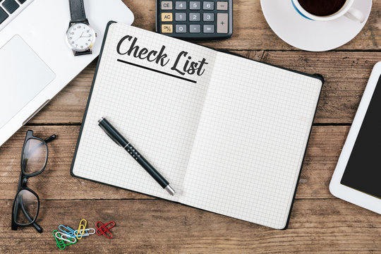 Check List text on note pad, Office desk with computer technolog