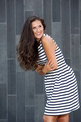 attractive young woman laughing with arms crossed