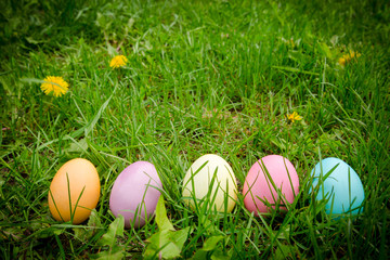 background with easter eggs on meadow with space for text