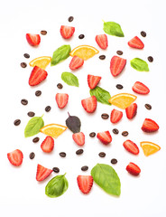 coffee beans, strawberry , orange, sheets of basil on white background