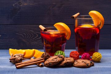tea or mulled wine with cinnamon, orange, pinecone at christmas