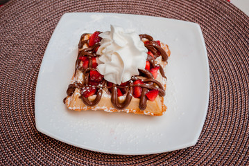 Belgian waffle with whip cream, caramel and strawberrys