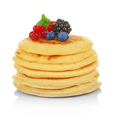 Delicious pancakes decorated with berries isolated on white