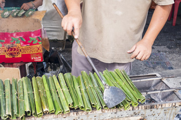 Man making thai dessert called "Kanom Jak" © wareelak