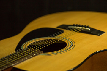 Acoustic guitar on black background