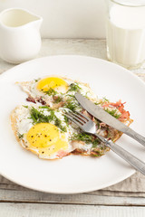 fried eggs with bacon on a plate