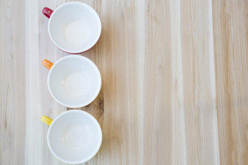 colorful mugs on wood table 