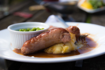 Traditional british bangers and mash served pub-style.