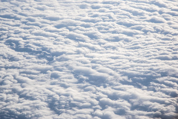 Banks of pristine, undulating clouds as seen from above