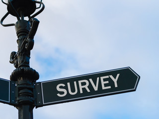 SURVEY directional sign on guidepost