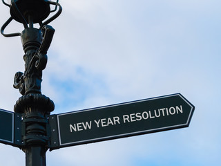 NEW YEAR RESOLUTION directional sign on guidepost