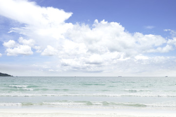 Fototapeta na wymiar Soft wave of blue and green ocean/sea on sandy beach with bright
