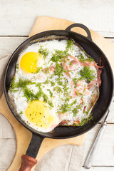 Fried eggs in a frying pan top view