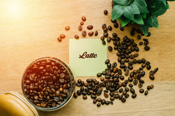 Business Concept, Top view showing a jar of coffee beans,leaf pot and a sticky written LATTE