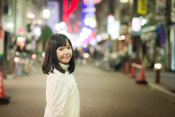 Fototapeta premium asian girl Girl walking on the night city street