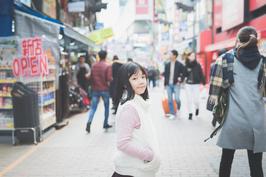 Beautiful Asian girl walking in the city