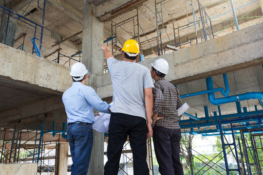 Construction concepts, Engineer and Architect working at Construction Site with blueprint