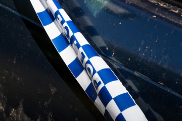 Police tape on abandoned crashed vehicle