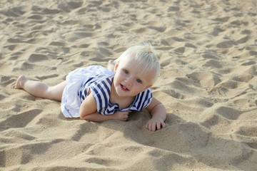 Cute blond baby girl on the beach
