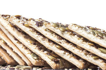 folded dry thin crispy biscuits sprinkled with sunflower seeds