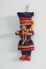 Finnish arctic doll girl hanging on a white wall