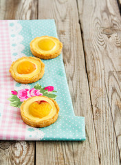 Mini tarts on tablecloth.